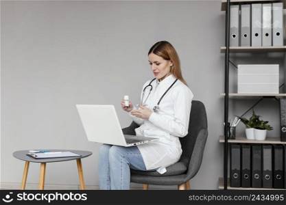 medium shot doctor sitting with computer