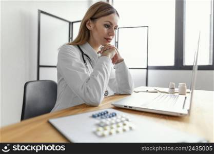 medium shot doctor with laptop