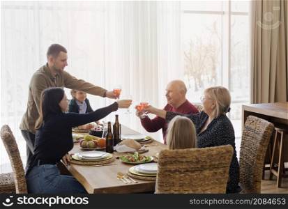 medium shot family members table