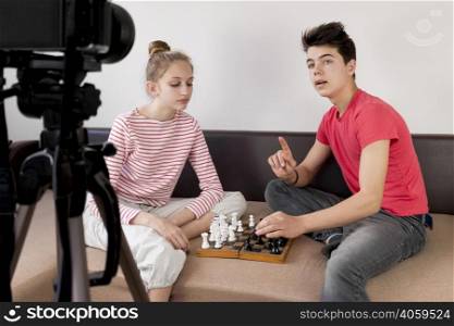 medium shot friends playing chess