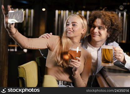 medium shot friends taking selfie pub