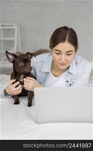 medium shot girl bed with laptop dog