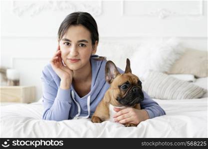 medium shot girl holding dog bed