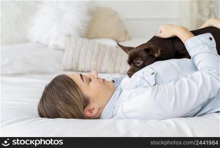 medium shot girl laying bed with dog