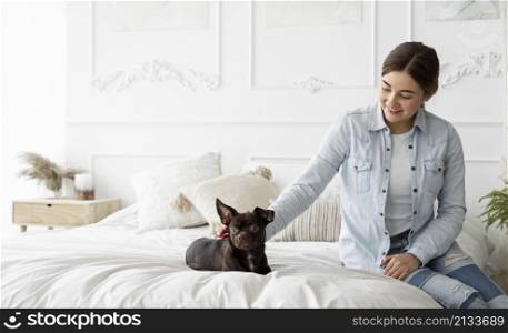 medium shot girl petting dog bed