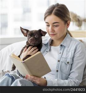 medium shot girl reading with dog