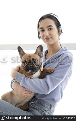 medium shot girl with headphones dog