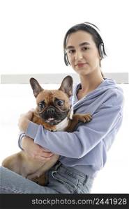 medium shot girl with headphones dog