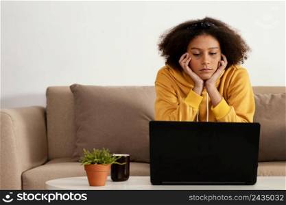 medium shot girl with laptop couch