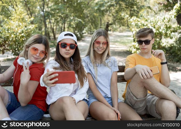 medium shot group friends taking selfie