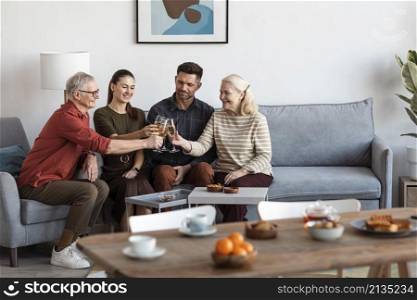 medium shot happy family clinking glasses