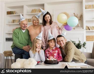 medium shot happy family posing with cake