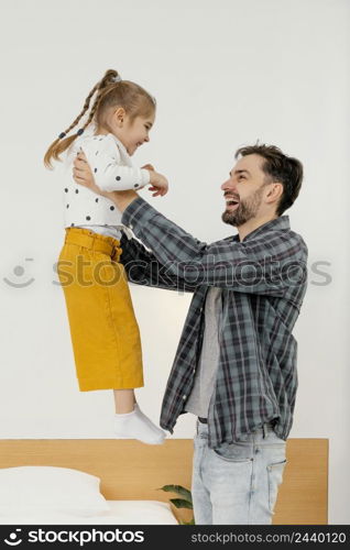 medium shot happy father holding kid