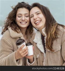 medium shot happy women with coffee cups