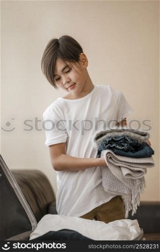 medium shot kid holding clothes