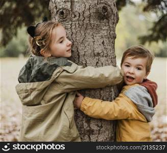medium shot kids hugging tree