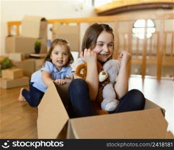 medium shot kids with cardboard box