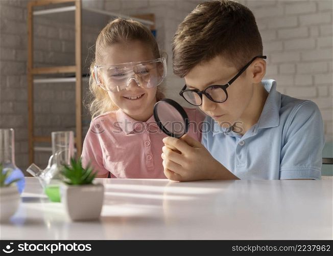 medium shot kids with magnifying glass