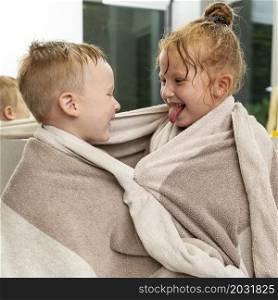 medium shot kids with towel indoors