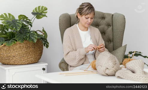 medium shot knitting woman home