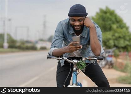 medium shot man bicycle with phone