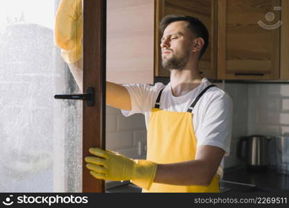 medium shot man cleaning window