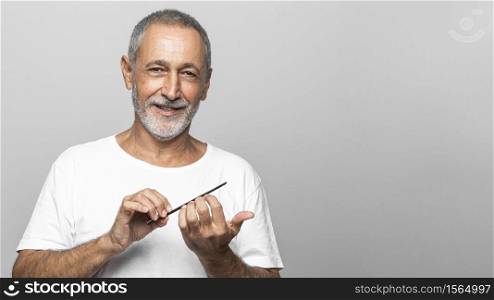 medium shot man filing his nails