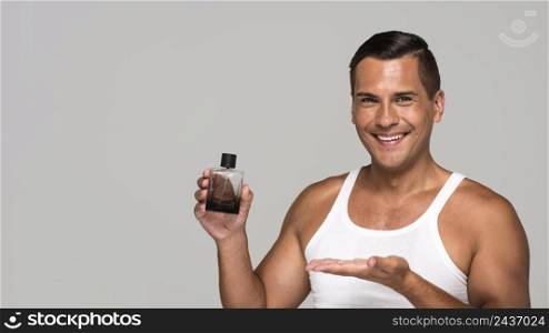 medium shot man holding cologne