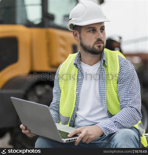 medium shot man holding laptop
