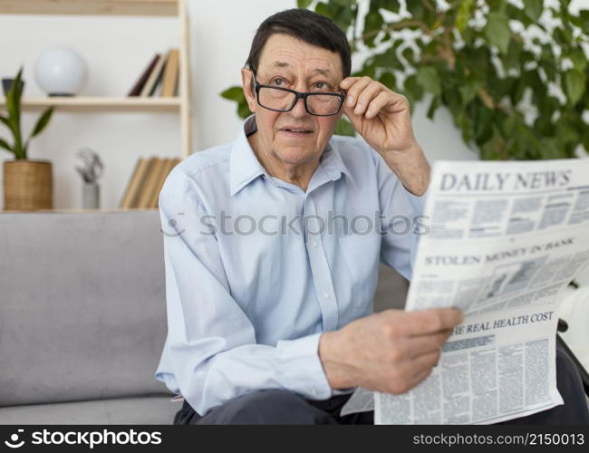 medium shot man holding newspaper