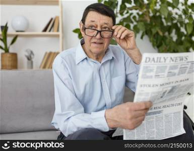 medium shot man holding newspaper