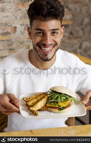 medium shot man holding plate with food