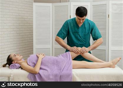medium shot man massaging knee
