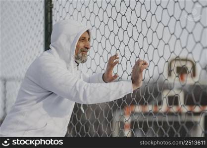 medium shot man near fence