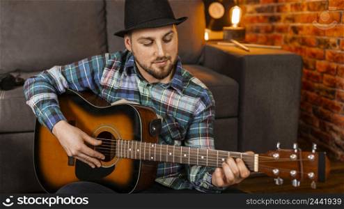 medium shot man playing guitar 2