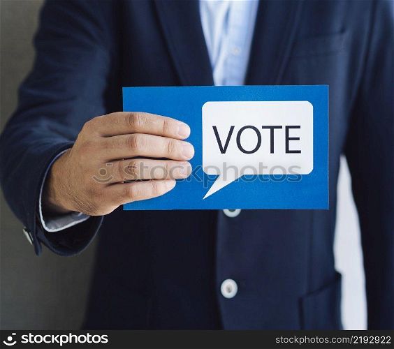 medium shot man showing voting card with speech bubble