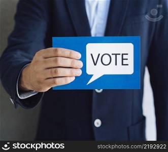 medium shot man showing voting card with speech bubble