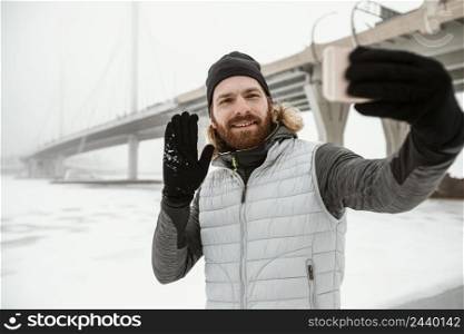 medium shot man taking selfie