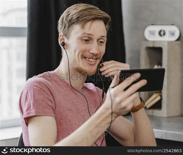 medium shot man wearing earphones