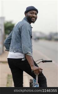 medium shot man with bicycle posing