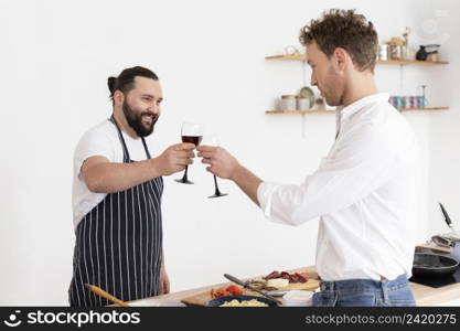 medium shot men clinking glasses