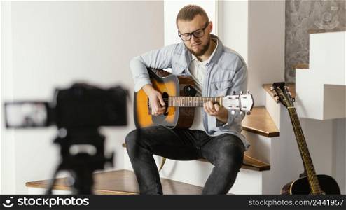 medium shot musician recording himself