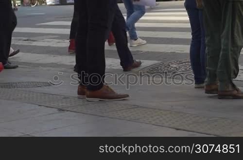 Medium shot of feet crossing the street in downtown Buenos Aires Argentina in slow motion series 3
