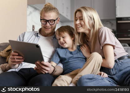 medium shot parents kid with tablet