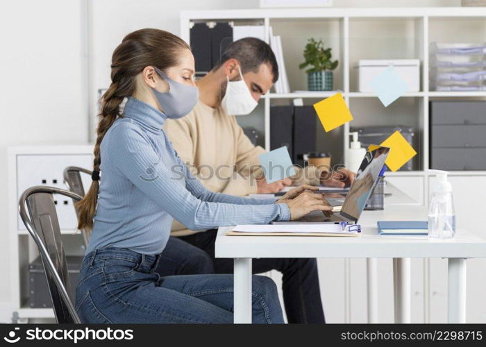 medium shot people working with masks