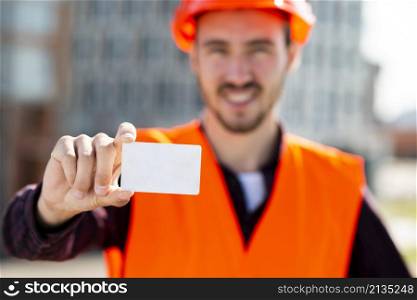 medium shot portrait construction engineer holding business card