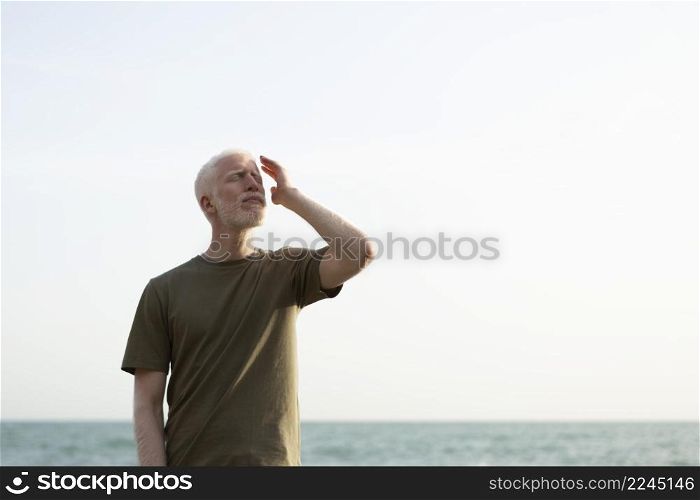 medium shot senior man posing seaside