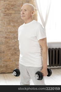 medium shot senior man with dumbbells