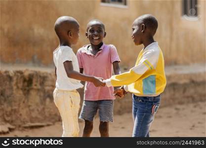 medium shot smiley african boys playing together