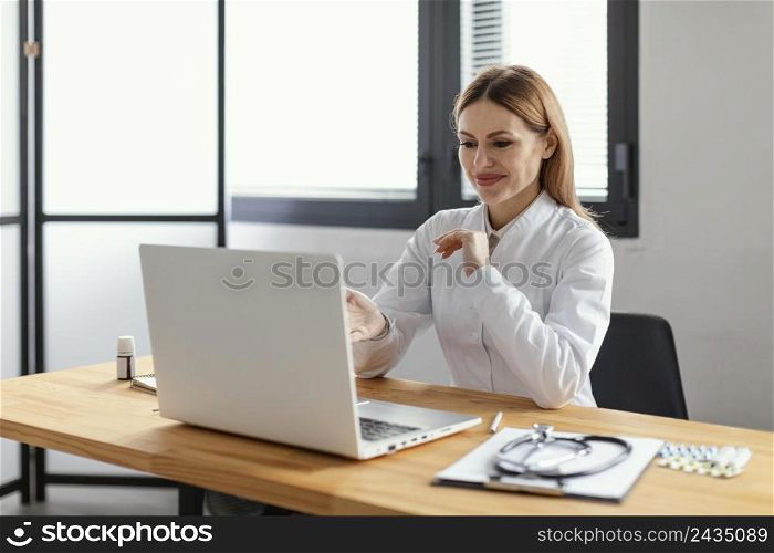 medium shot smiley doctor with laptop